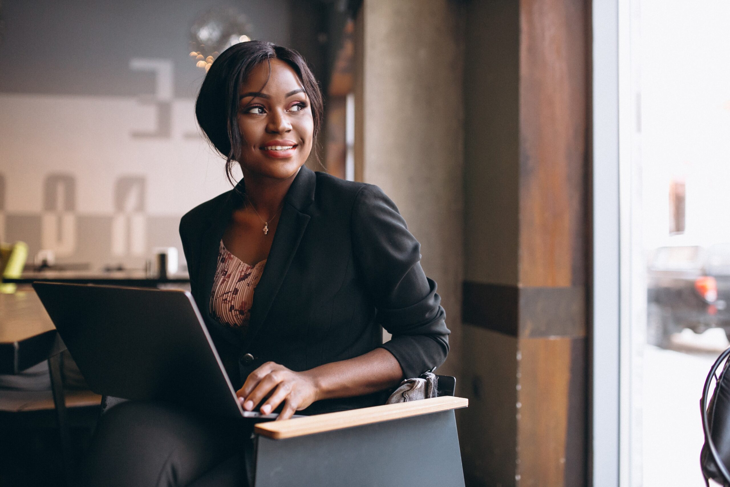 African american business woman working on a computer in a bar